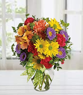 Mixed Flowers Arrangement In A Glass Vase